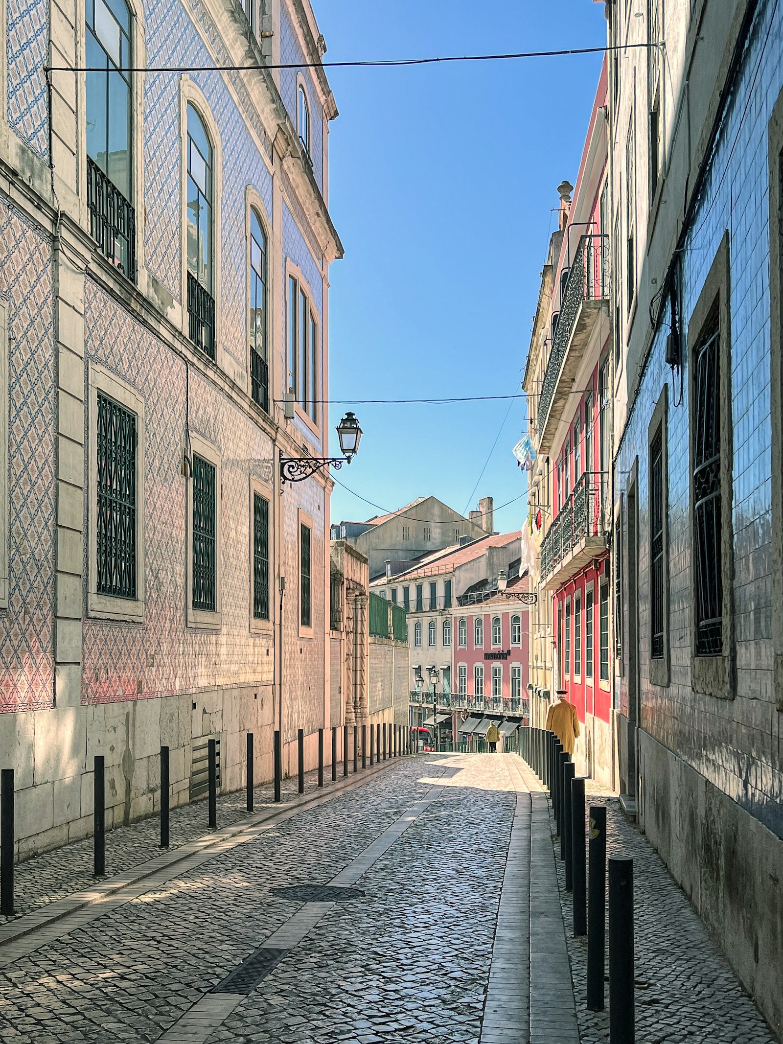 Narrow street with tiled facades and a street lamp
